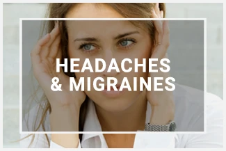 A woman stares into the distance while massaging her head, trying to alleviate a headache