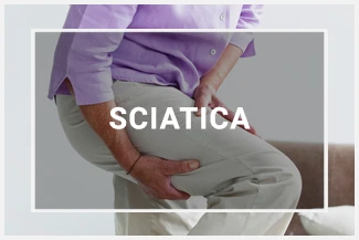 A woman clutching her let in pain, caused by sciatica