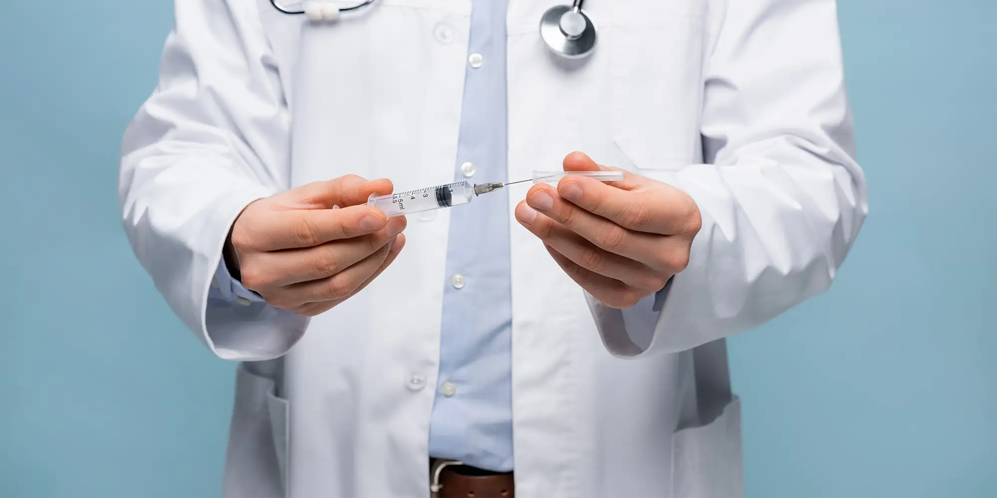Physical Medicine Columbus GA Doctor Holding Syringe Doctor In Lab Coat Holding A Syringe For Trigger Point Injections