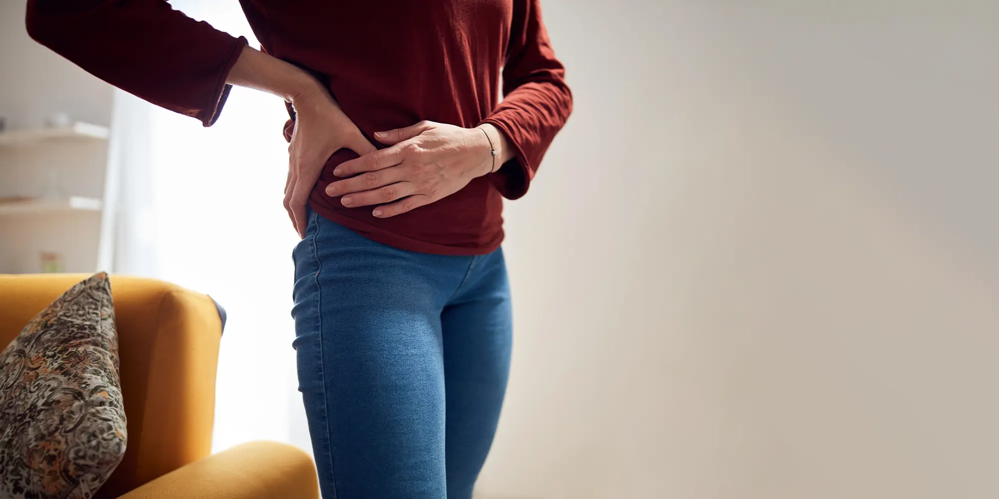 Person With Hip Pain holding their right side in pain
