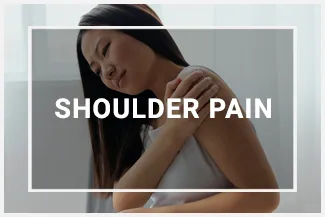 A woman reaching to hold her shoulder, her face twisted in pain