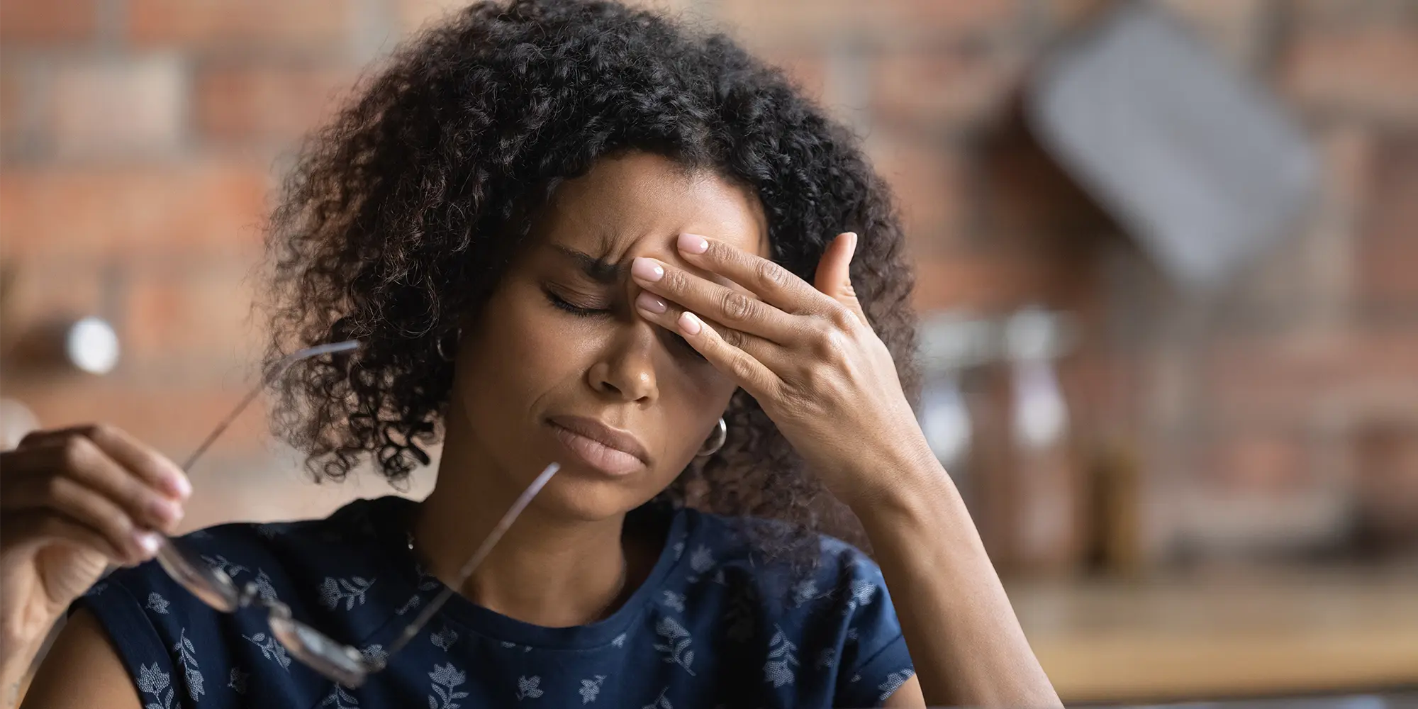 Physical Medicine Columbus GA Woman With Migraine Woman With Migraine looking pained with her hand to her forehead